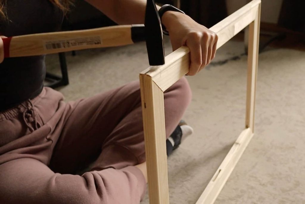 woman assembling a stretcher frame